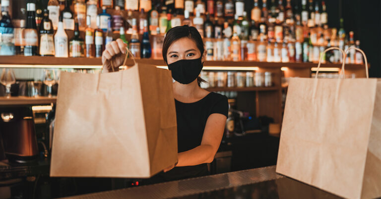 Restaurant staff providing takeout service during challenging times