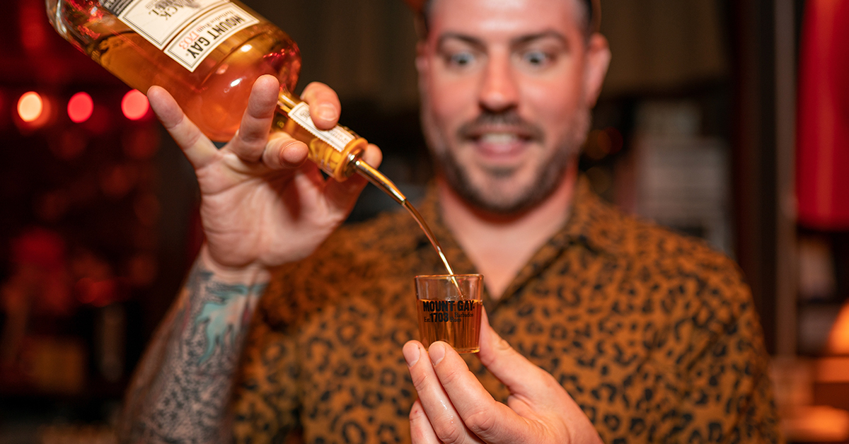 Bartender Chris Elford pouring rum during a specialty pop-up cocktail event