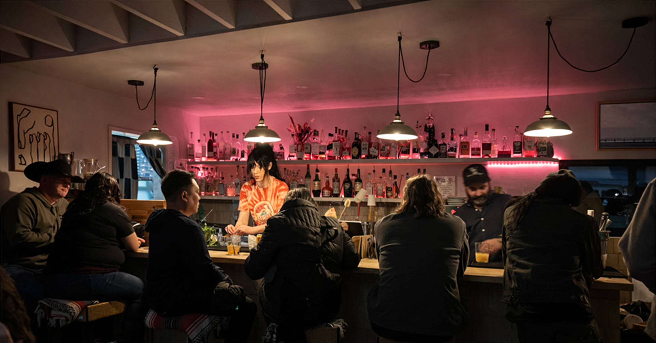 Modern bar safety in action at Más o Menos in Joshua Tree, showing bartenders serving patrons in a well-managed bar environment