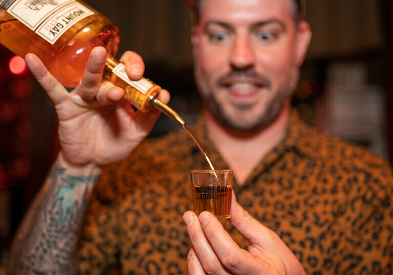 Bartender Chris Elford pouring rum during a specialty pop-up cocktail event