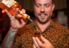 Bartender Chris Elford pouring rum during a specialty pop-up cocktail event